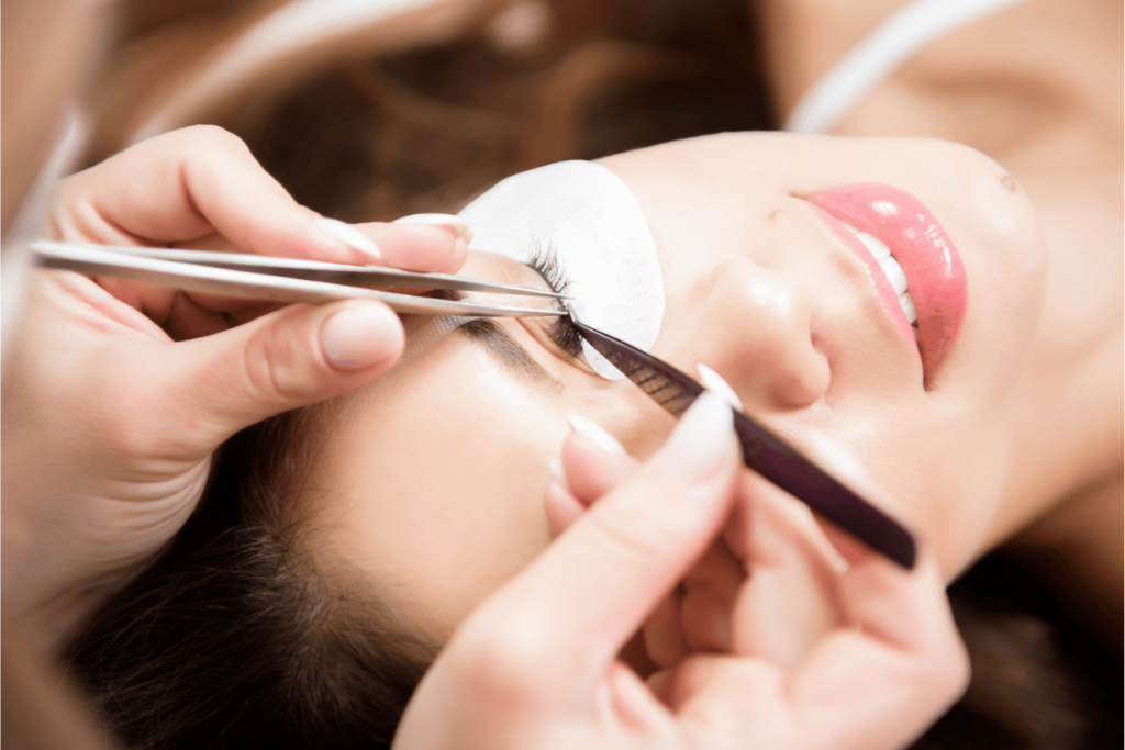 A close up of a woman getting silk eyelash extensions.