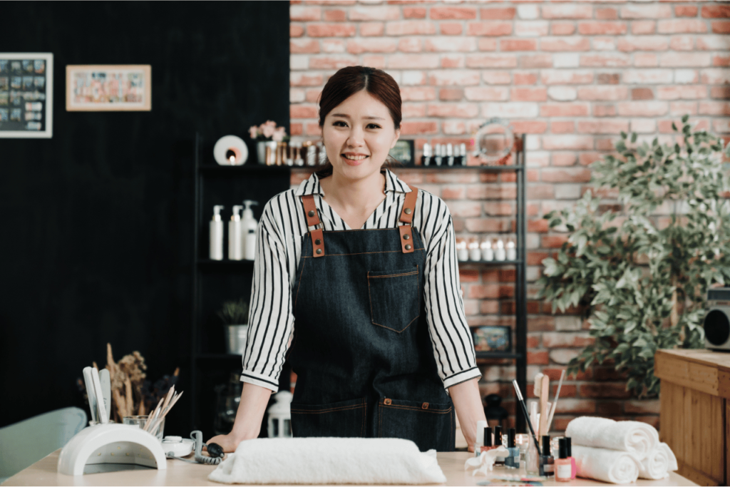 A friendly nail technician ready to talk about nail salon terms.