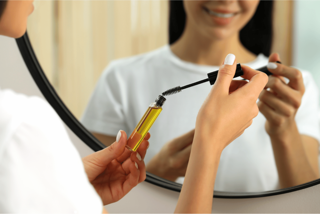 closeup of a woman using a diy eyelash growth serum.