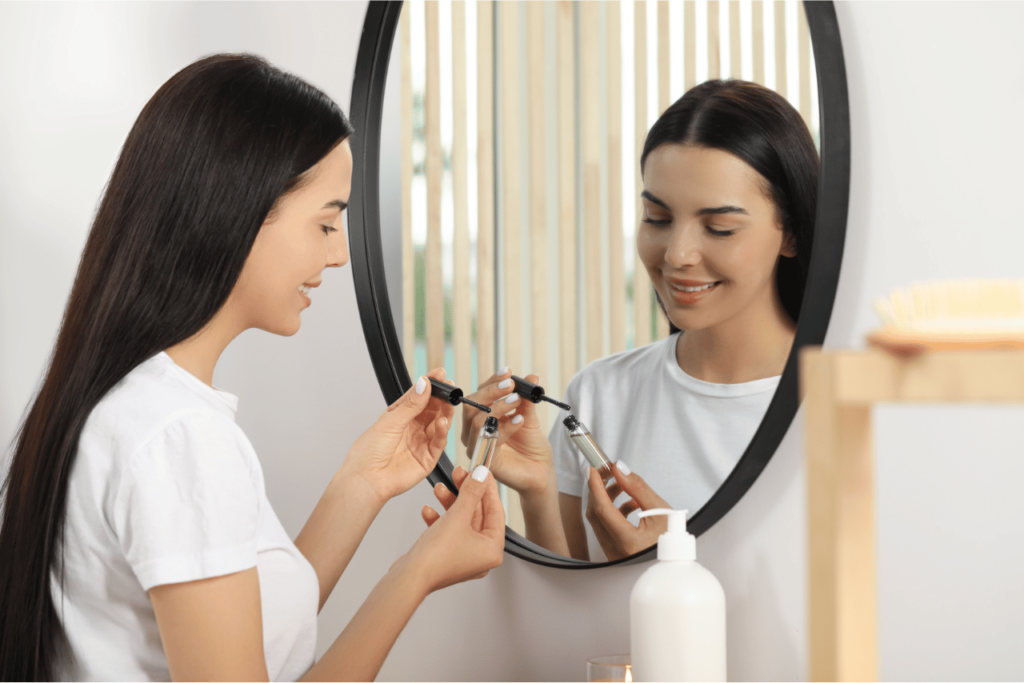 A woman using a DIY eyelash growth serum.